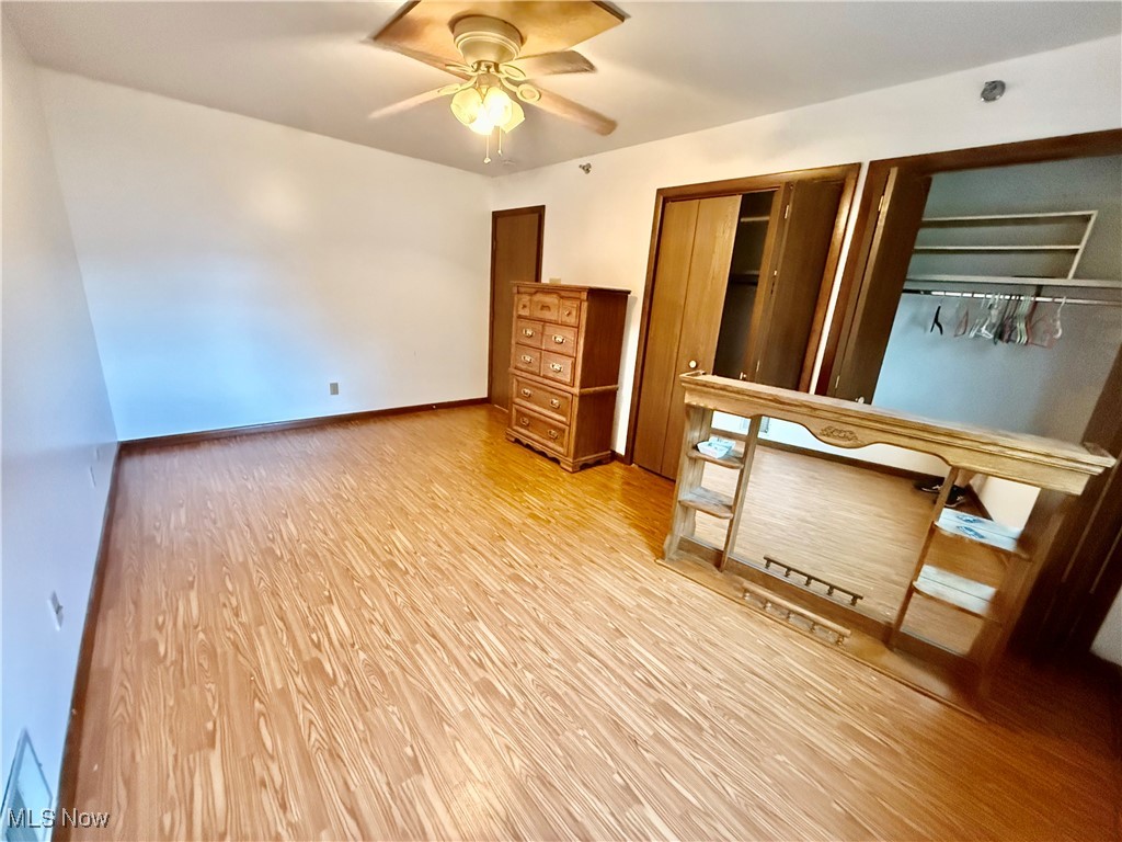 2749 Norton Road Stow, OH 44224 - Photo 11 of 24 Bedroom featuring light wood-style floors, multiple closets, and ceiling fan