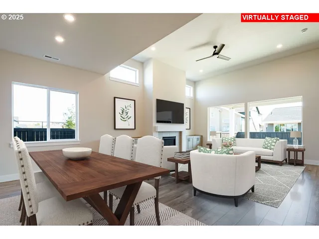 a living room with furniture a flat screen tv and a large window