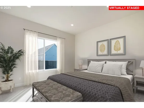 a bedroom with a large window and a potted plant