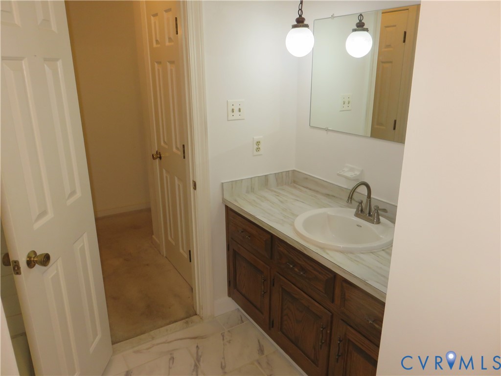 8379 Quailfield Road Mechanicsville, VA 23116 - Photo 33 of 56 a bathroom with a sink and a mirror