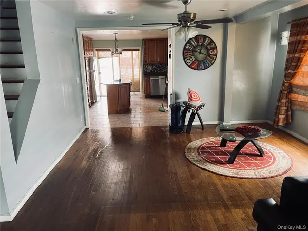 a living room with table and chairs with wooden floor