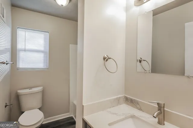 a bathroom with a toilet and a sink