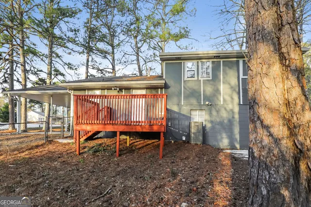 a backyard of a house with barbeque oven table and chairs