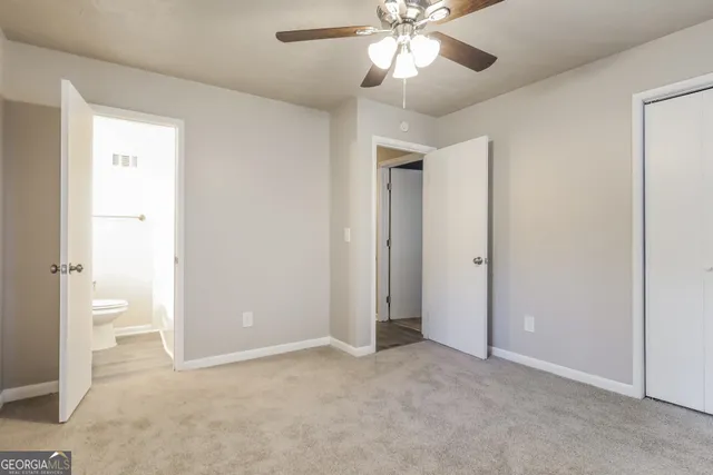 an empty room with fan and entrance