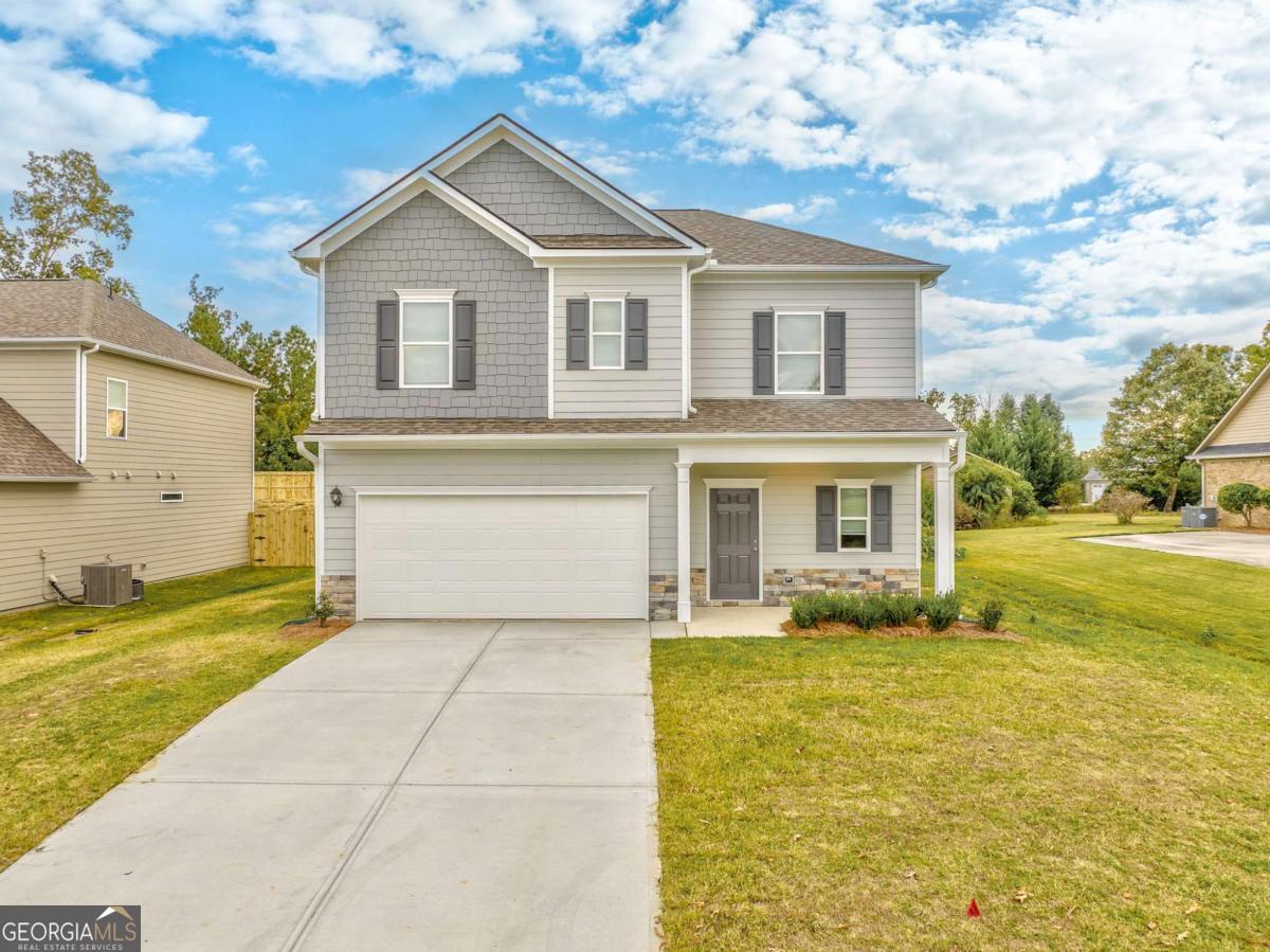 a view of house that has a yard
