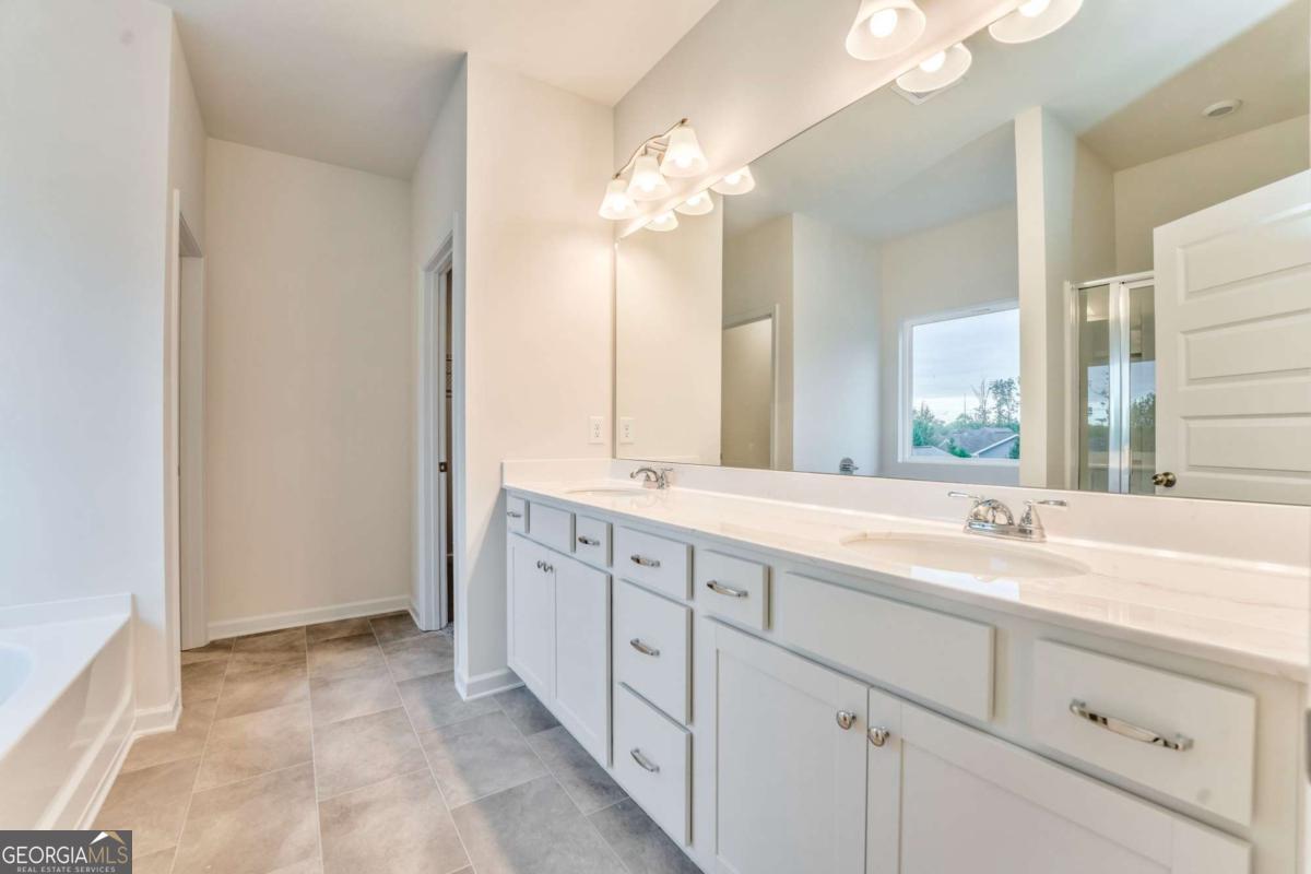 8 Majestic Oaks Way Northeast Rome, GA 30165 - Photo 21 of 25 a spacious bathroom with a double vanity sink and a mirror