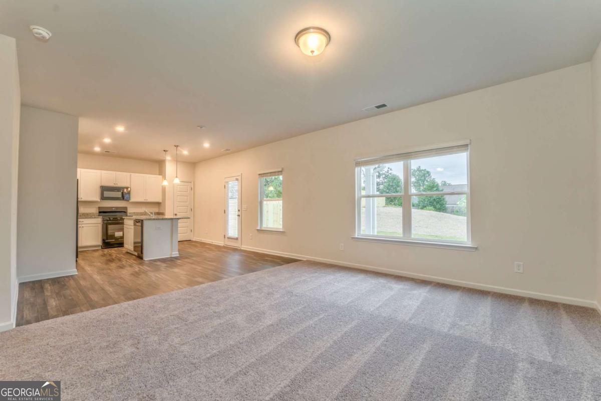 8 Majestic Oaks Way Northeast Rome, GA 30165 - Photo 5 of 25 an empty room with a kitchen view and a window