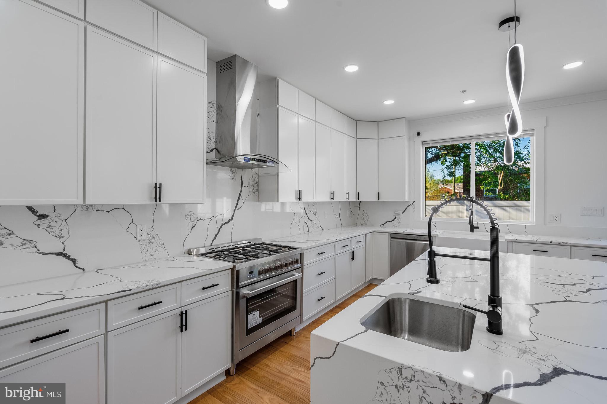 4626 Brooks Street Northeast Washington, DC 20019 - Photo 12 of 65 a kitchen with stainless steel appliances granite countertop a sink stove and refrigerator