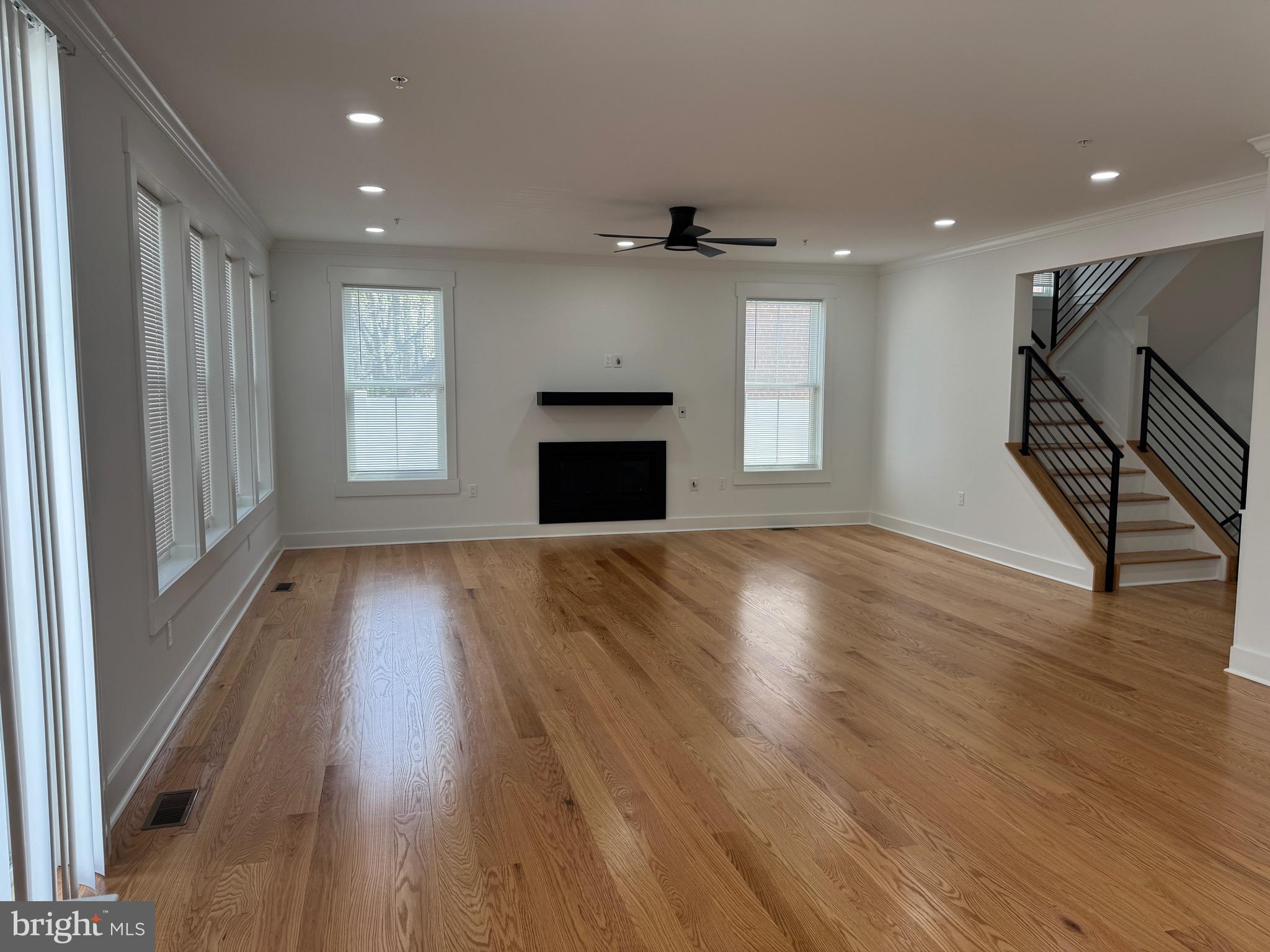 4626 Brooks Street Northeast Washington, DC 20019 - Photo 13 of 65 an empty room with wooden floor fireplace and windows