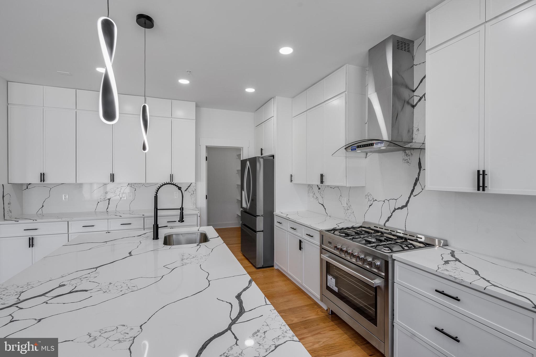 4626 Brooks Street Northeast Washington, DC 20019 - Photo 16 of 65 a kitchen with stainless steel appliances kitchen island a sink stove and refrigerator
