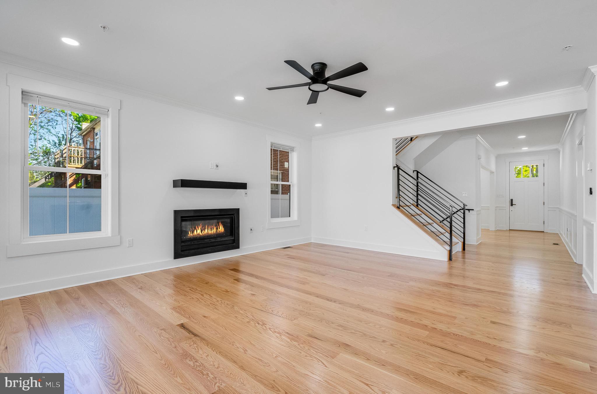 4626 Brooks Street Northeast Washington, DC 20019 - Photo 23 of 65 a view of an empty room with wooden floor fireplace and a window