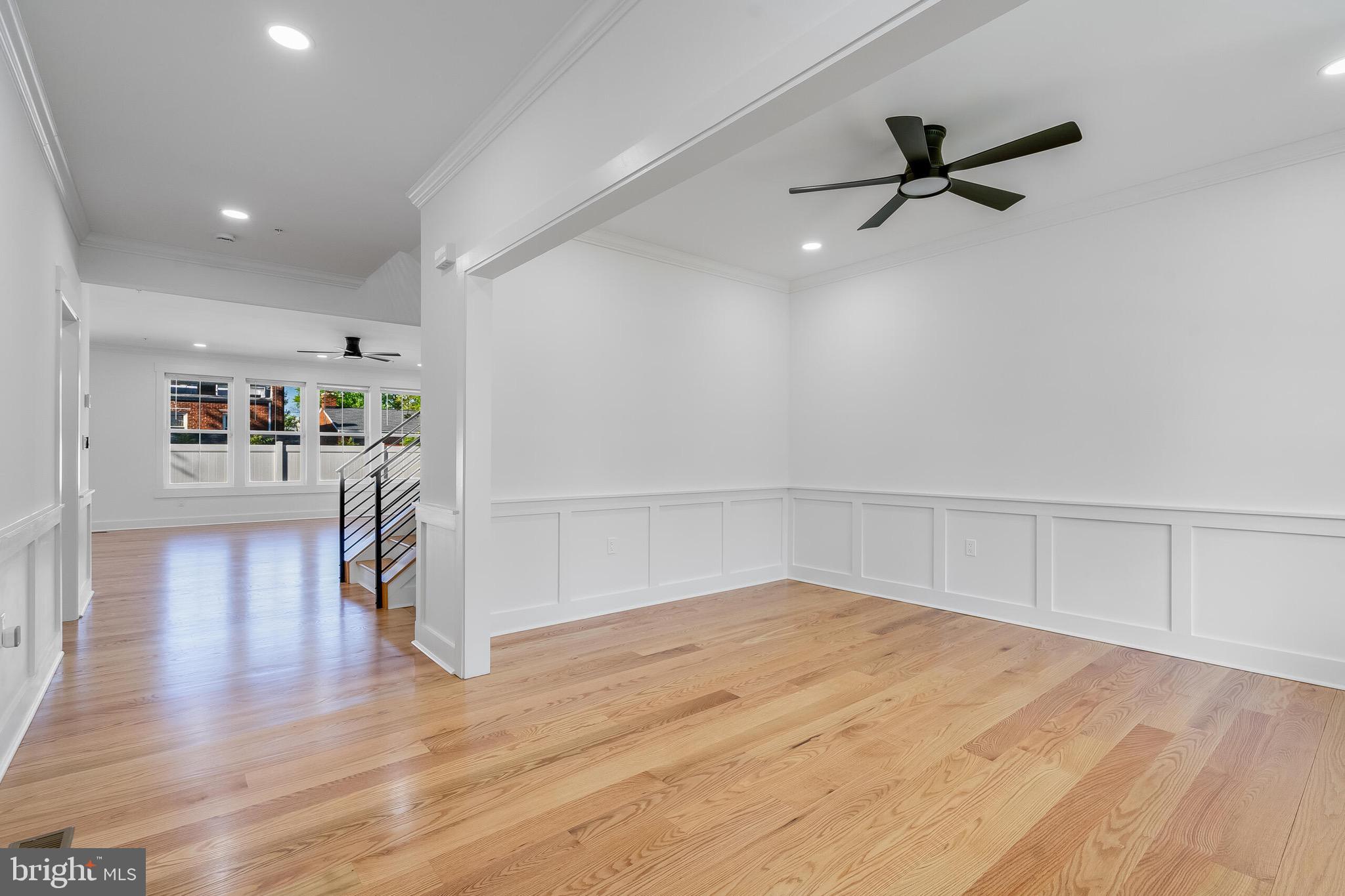 4626 Brooks Street Northeast Washington, DC 20019 - Photo 26 of 65 a view of a livingroom with a furniture wooden floor ceiling fan and windows