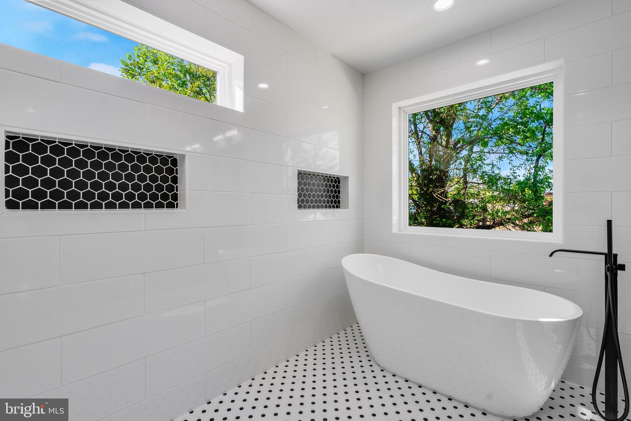 4626 Brooks Street Northeast Washington, DC 20019 - Photo 35 of 65 a white bath tub sitting in a bathroom next to a window