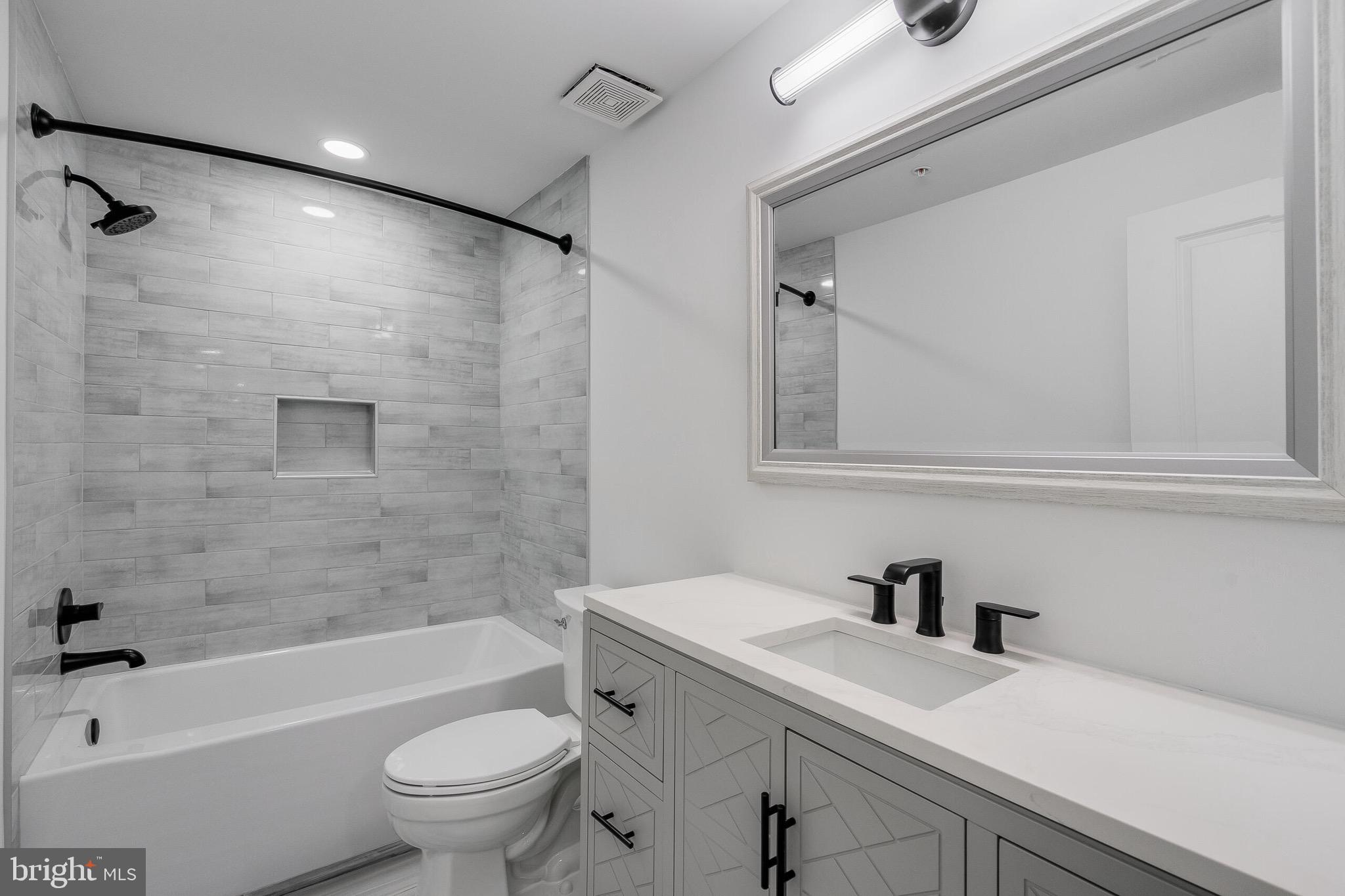 4626 Brooks Street Northeast Washington, DC 20019 - Photo 39 of 65 a bathroom with a sink a toilet and a bathtub