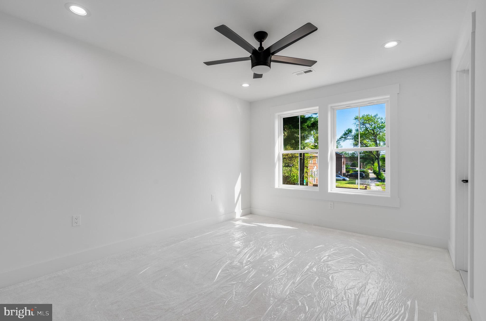 4626 Brooks Street Northeast Washington, DC 20019 - Photo 49 of 65 an empty room with windows and ceiling fan