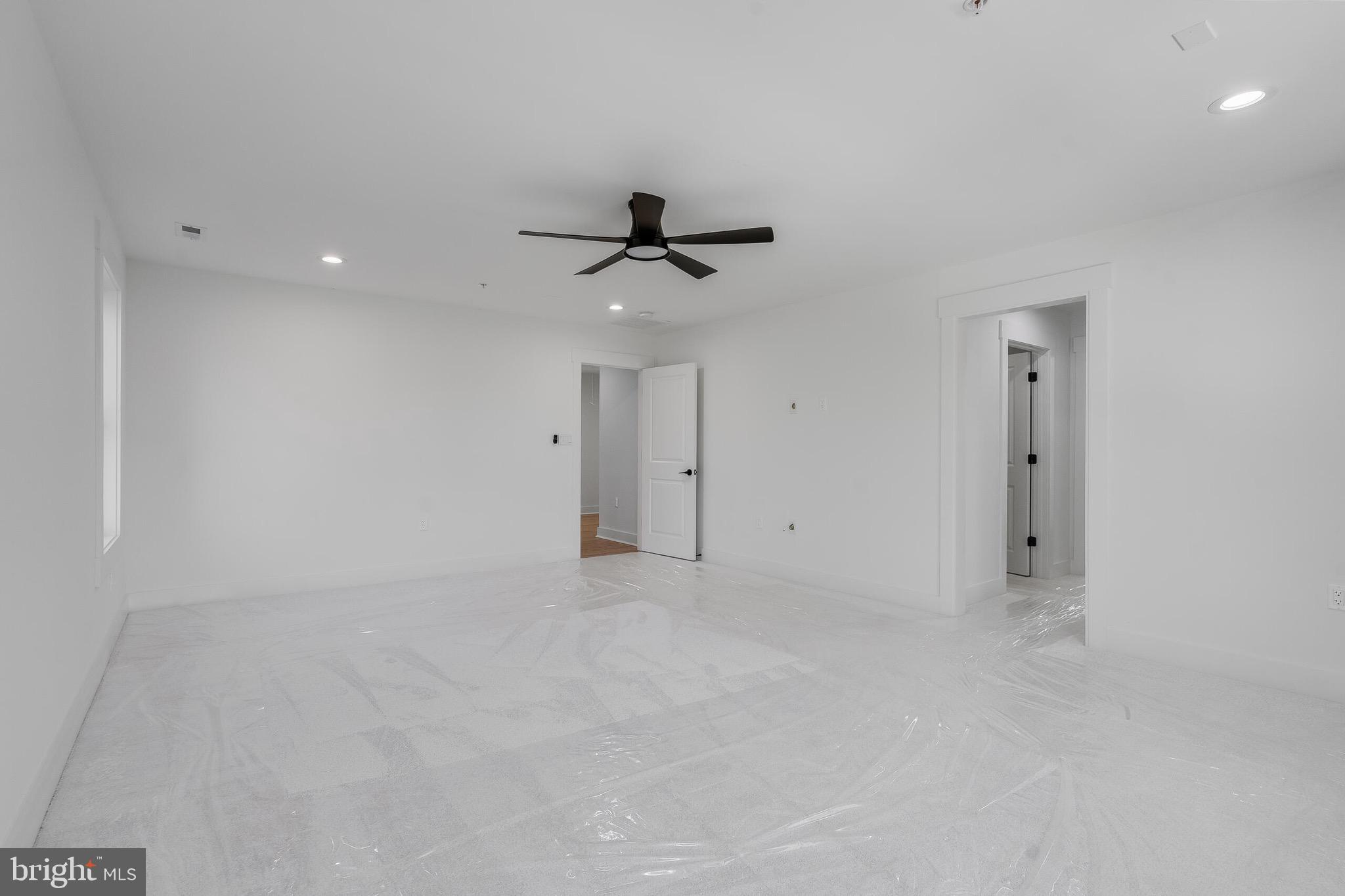 4626 Brooks Street Northeast Washington, DC 20019 - Photo 50 of 65 an empty room with a ceiling fan and a window