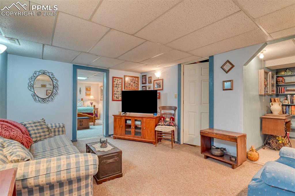 22500 Enoch Road Calhan, CO 80808 - Photo 11 of 39 a living room with furniture and a flat screen tv