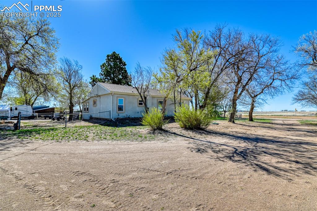 22500 Enoch Road Calhan, CO 80808 - Photo 14 of 39 a front view of a house with a yard and garage