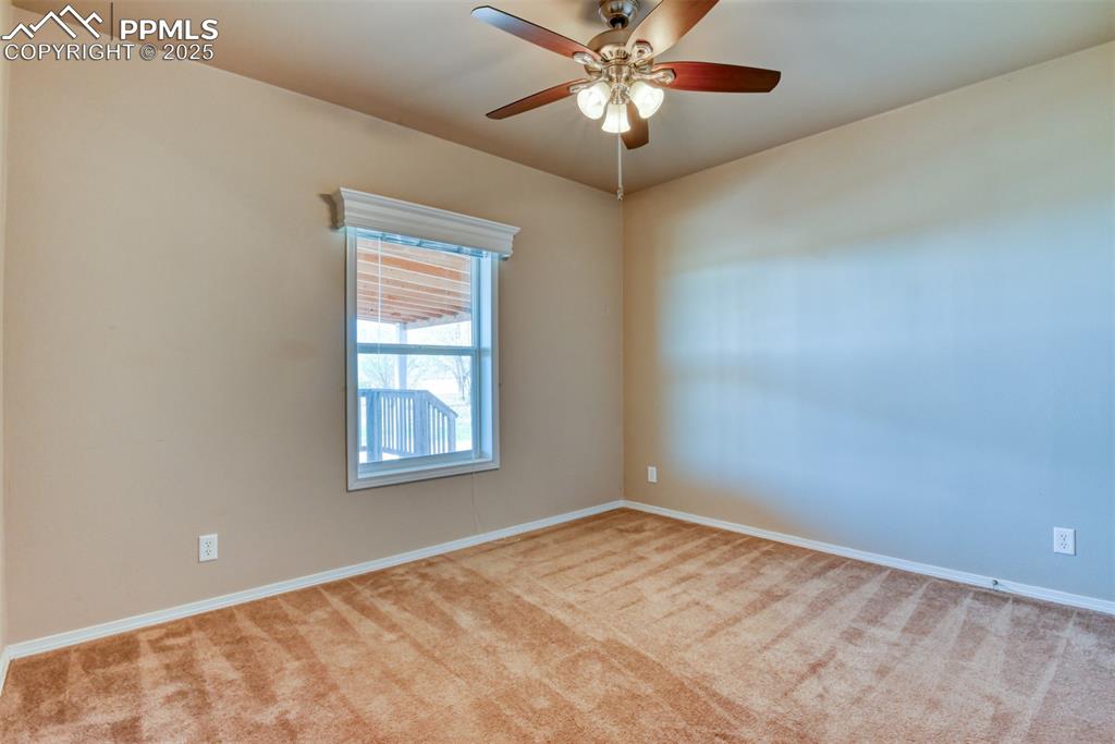 22500 Enoch Road Calhan, CO 80808 - Photo 21 of 39 an empty room with a window and a fan
