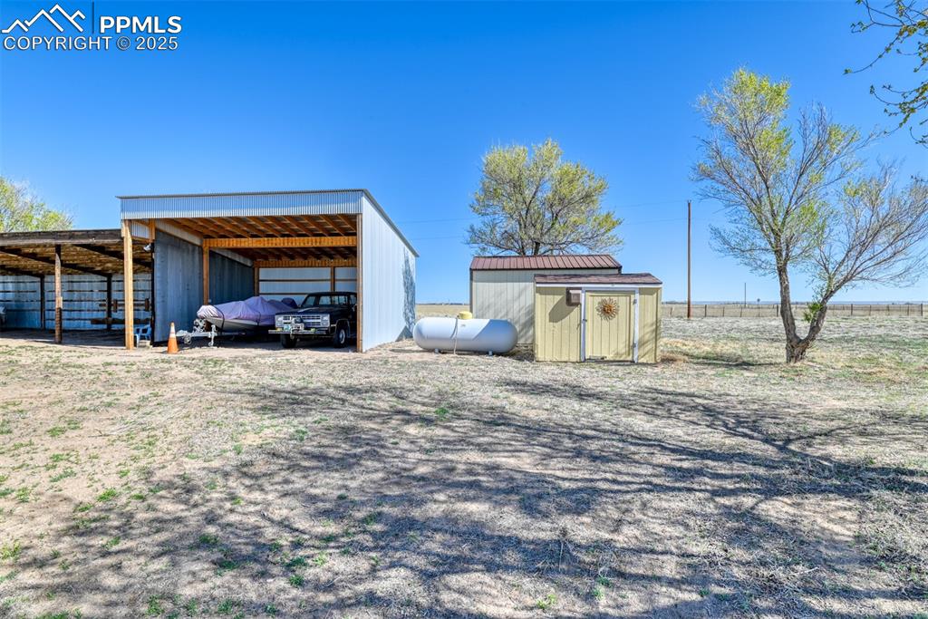22500 Enoch Road Calhan, CO 80808 - Photo 26 of 39 a view of a house with a yard and garage