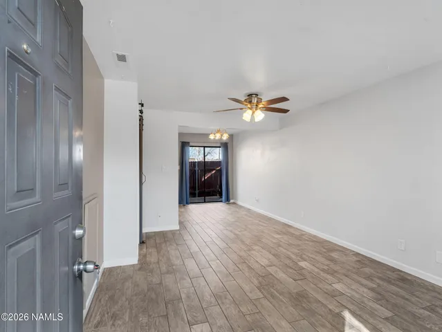 a view of empty room with wooden floor