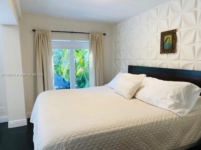 256 Southwest 30th Road Miami, FL 33129 - Photo 12 of 17 a large white bed in a bedroom next to a window