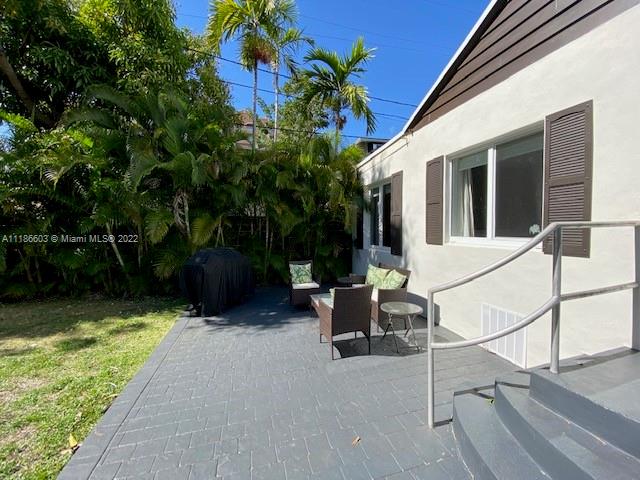 256 Southwest 30th Road Miami, FL 33129 - Photo 15 of 17 a view of backyard with outdoor seating and plants