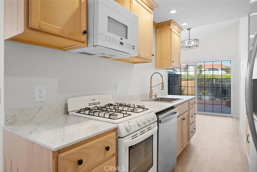 a kitchen with stainless steel appliances granite countertop a sink stove and cabinets