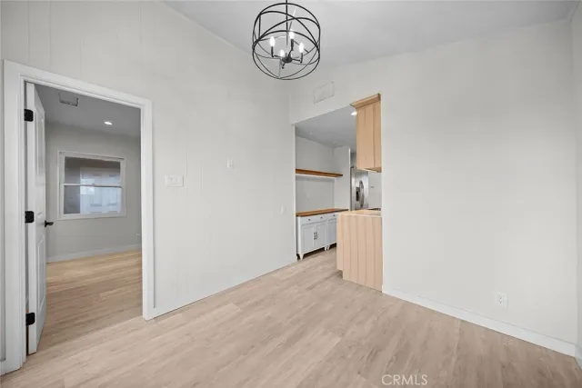 a kitchen with kitchen island granite countertop a refrigerator a sink and a stove