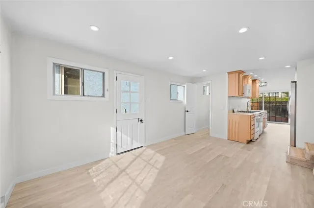 a view of a kitchen with a sink and wooden floor