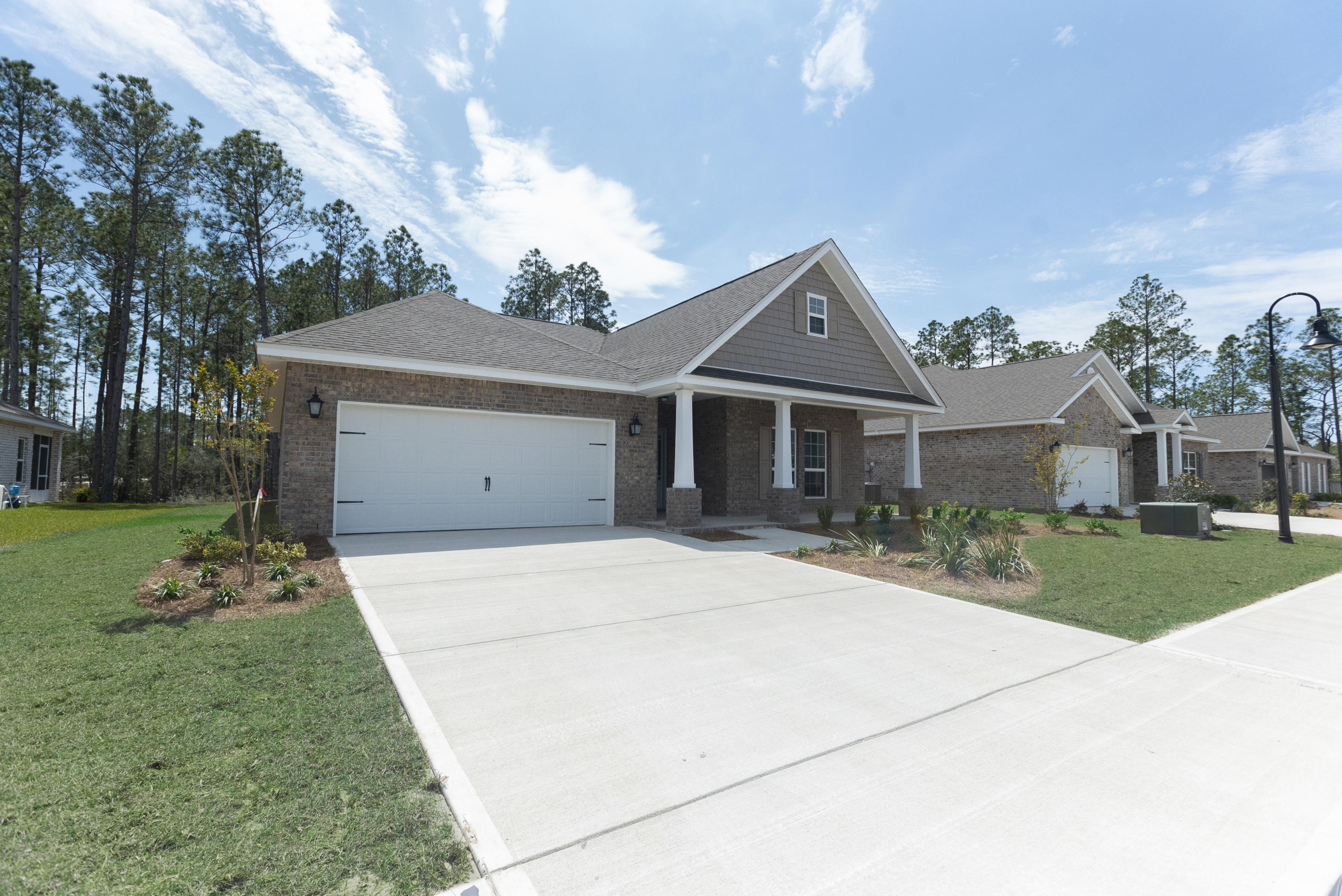 72 Conner Circle Santa Rosa Beach, FL 32459 - Photo 18 of 42 a front view of a house with a garden and trees