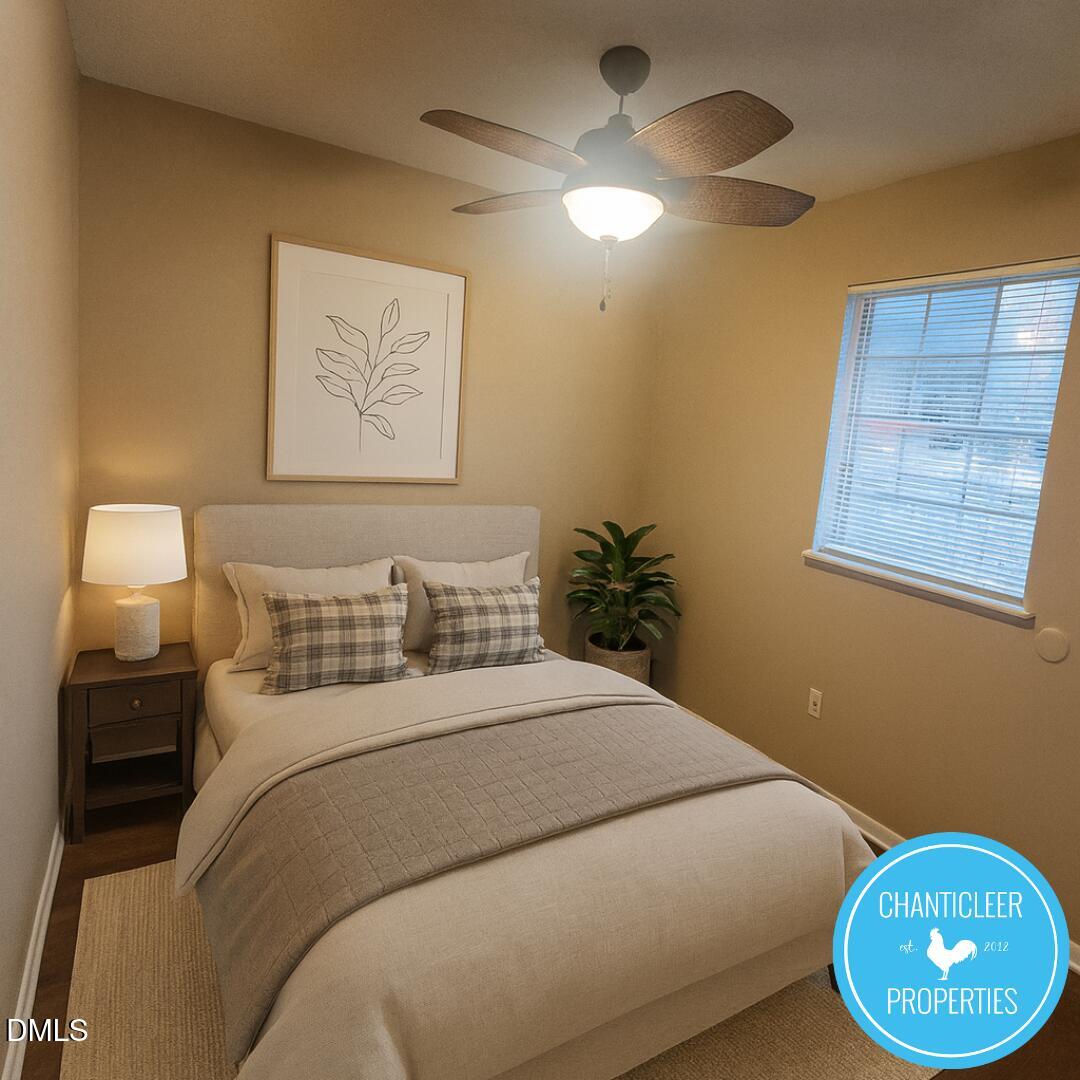 115 Florence Street, Unit 2 Graham, NC 27253 - Photo 11 of 12 a bedroom with a bed and a painting on the wall