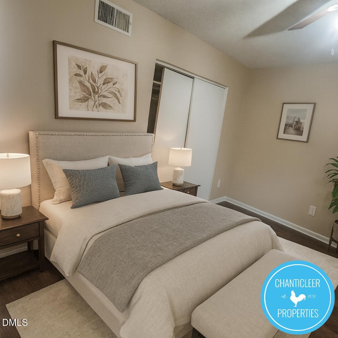 115 Florence Street, Unit 2 Graham, NC 27253 - Photo 5 of 12 a bedroom with bed and wall painting