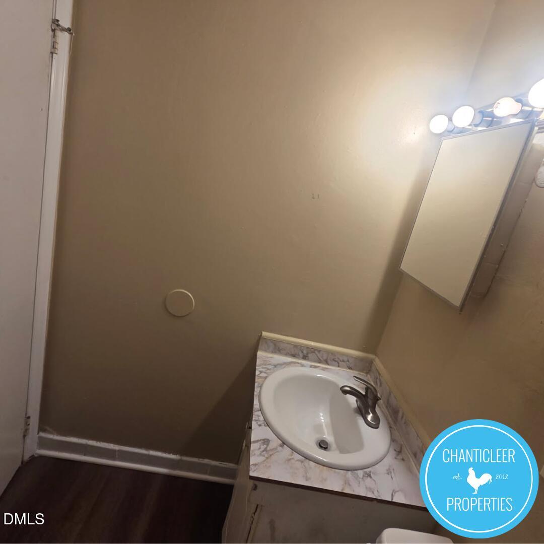 115 Florence Street, Unit 2 Graham, NC 27253 - Photo 8 of 12 a bathroom with a sink and a mirror