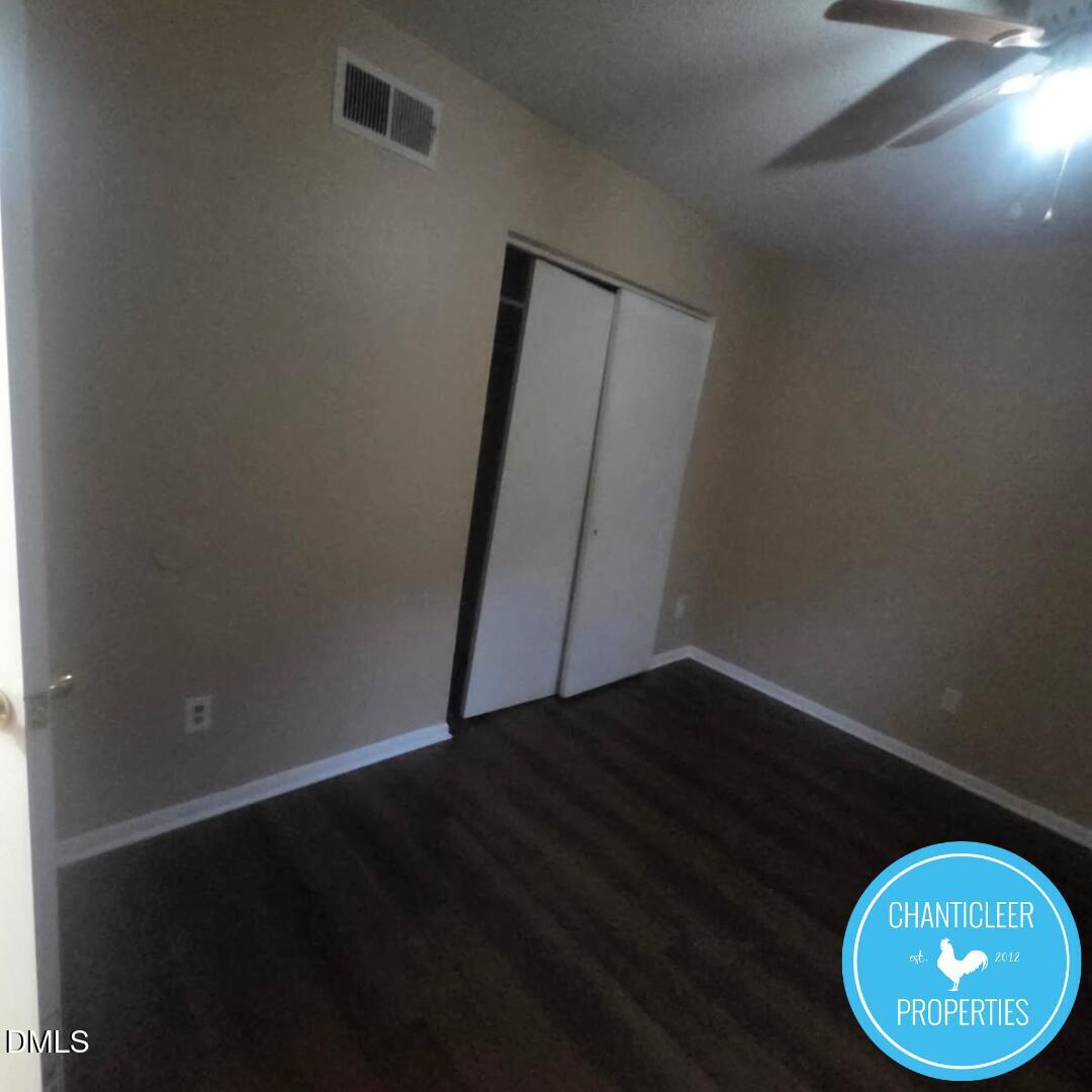 115 Florence Street, Unit 2 Graham, NC 27253 - Photo 9 of 12 an empty room with wooden floor and windows