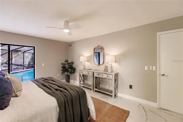 a bedroom with a bed a chandelier and dresser
