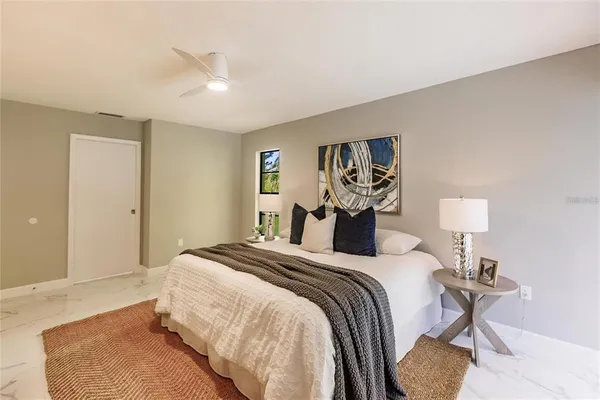 a bedroom with a bed and a painting on the wall