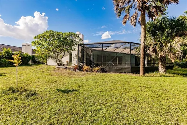 a view of a house with backyard and sitting area