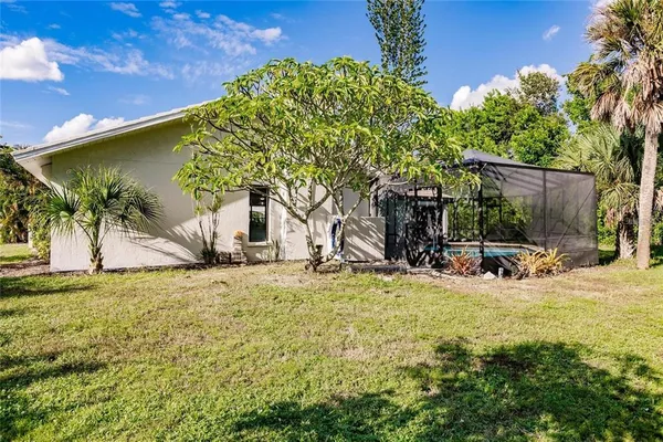 a view of a house with backyard and sitting area
