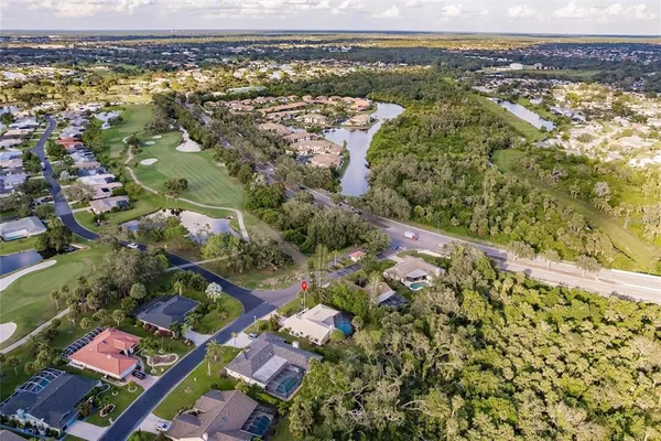 an aerial view of residential houses with outdoor space and swimming pool