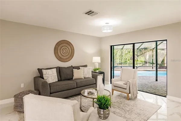 a living room with furniture and a large window