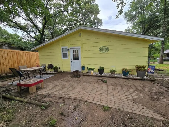 a backyard of a house with outdoor seating