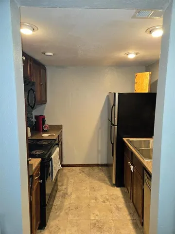 a spacious bedroom with a bed and a mirror