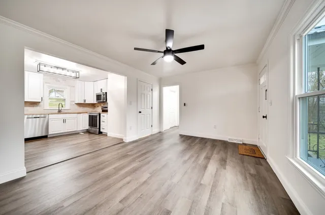 a kitchen with white cabinets and stainless steel appliances