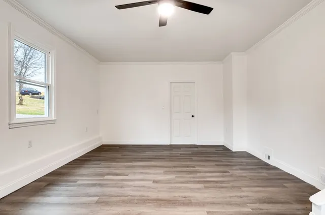 wooden floor in an empty room with a window