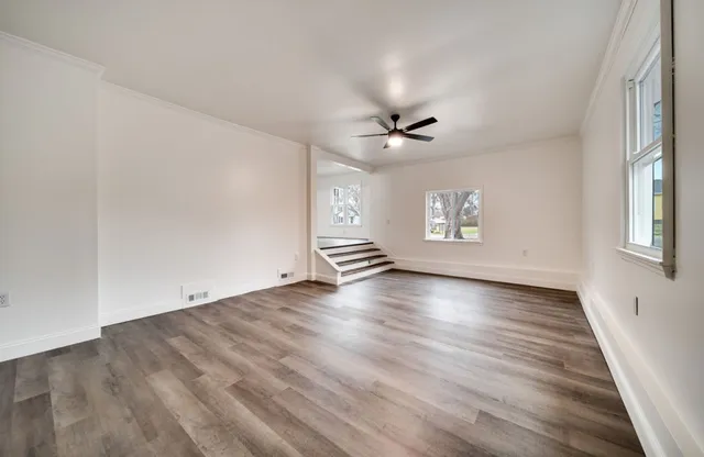 wooden floor in an empty room with a window
