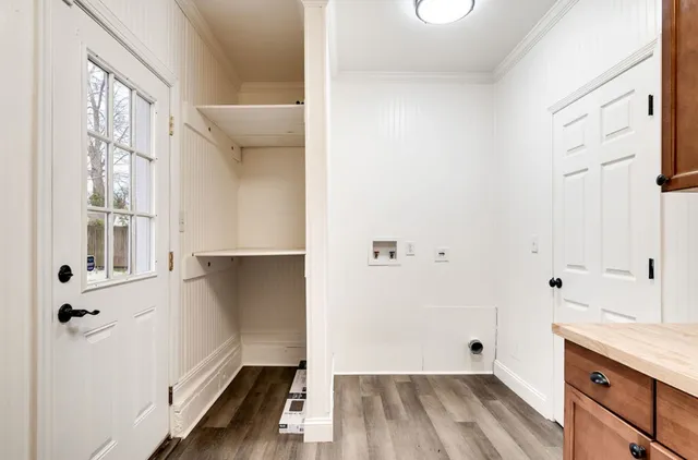 a view of a kitchen with wooden floor and cabinets