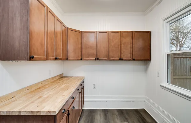a kitchen with microwave cabinets and stove top oven