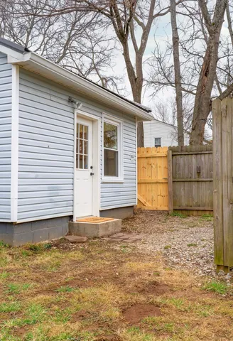 a white house that has a tree in front of it