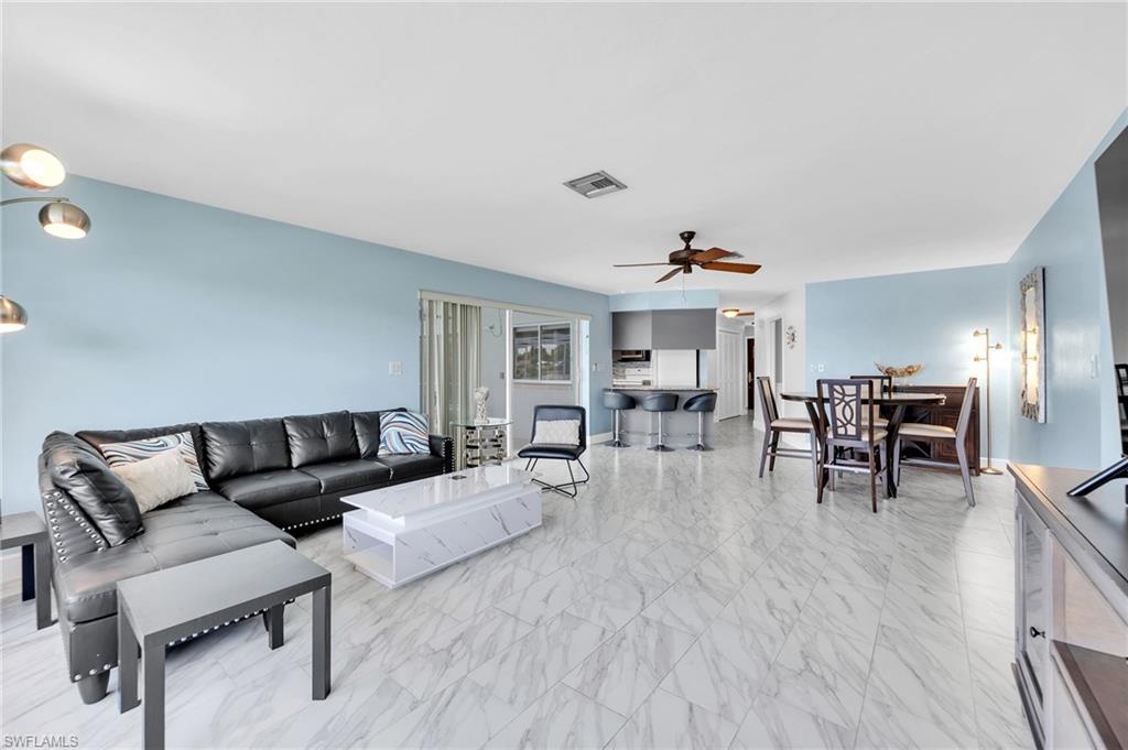 3065 50th Lane Southwest Naples, FL 34116 - Photo 7 of 31 a living room with furniture and wooden floor